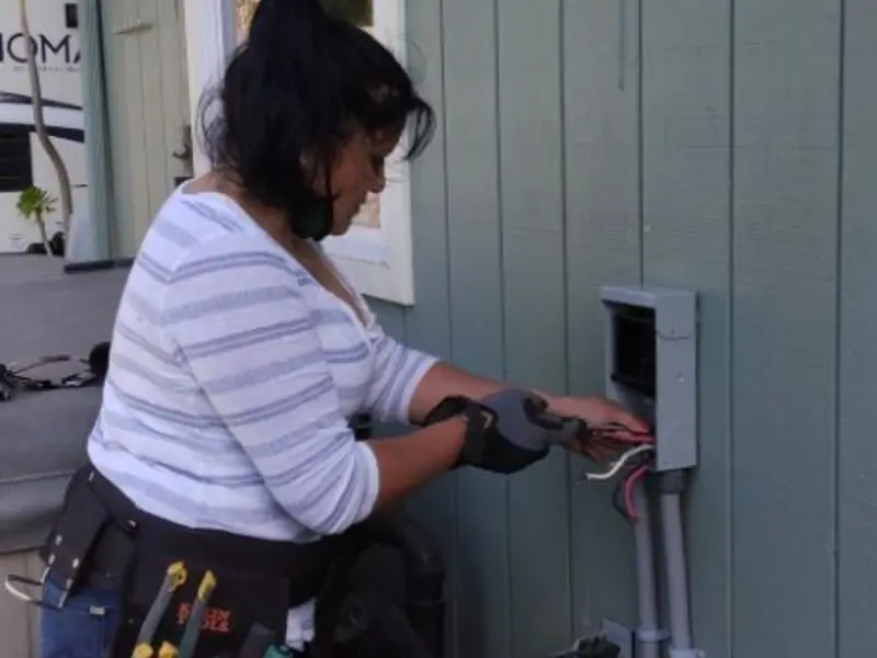Licensed electrician wiring an exterior subpanel in Niles
